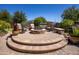 Backyard fire pit with seating area and brick design at 19334 W Pasadena Ave, Litchfield Park, AZ 85340