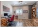 Bright home office features built-in shelving and hardwood floors at 19334 W Pasadena Ave, Litchfield Park, AZ 85340