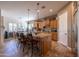 Bright kitchen featuring an island, wood cabinets, and stainless steel appliances at 19334 W Pasadena Ave, Litchfield Park, AZ 85340