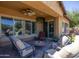 Covered patio with seating area and outdoor TV at 19334 W Pasadena Ave, Litchfield Park, AZ 85340