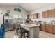 Kitchen featuring island, stainless steel appliances, and wood cabinets at 2016 N Ensenada Ln, Casa Grande, AZ 85122