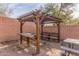 Wooden pergola with benches and a table at 2016 N Ensenada Ln, Casa Grande, AZ 85122