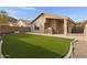 Landscaped backyard with artificial turf and fire pit at 2023 E Glenhaven Dr, Phoenix, AZ 85048