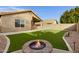 Artificial turf backyard with fire pit and built-in BBQ at 2023 E Glenhaven Dr, Phoenix, AZ 85048