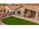 Backyard with artificial turf and built-in grill at 2023 E Glenhaven Dr, Phoenix, AZ 85048