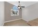 Bright bedroom with ceiling fan and large window at 2023 E Glenhaven Dr, Phoenix, AZ 85048