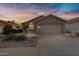 House exterior at sunset with two-car garage at 2023 E Glenhaven Dr, Phoenix, AZ 85048