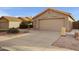 Tan house with tile roof, two-car garage, and desert landscaping at 2023 E Glenhaven Dr, Phoenix, AZ 85048