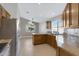 Spacious kitchen with granite countertops and wood cabinets at 2023 E Glenhaven Dr, Phoenix, AZ 85048