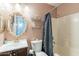 Bathroom with a tub, shower, and decorative mirror at 2057 E Brooks St, Gilbert, AZ 85296