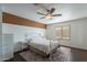 Bright bedroom with a metal bed frame, dresser, and ceiling fan at 2057 E Brooks St, Gilbert, AZ 85296