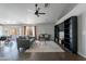 Living room features dark tile floors, a ceiling fan, and built-in shelving at 2057 E Brooks St, Gilbert, AZ 85296