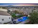 Aerial view of outdoor living space with pool, fire pit, seating and desert landscape at 20641 W Medlock Dr, Buckeye, AZ 85396