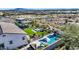 Aerial view of backyard with pool, outdoor kitchen, fire pit, and desert landscaping at 20641 W Medlock Dr, Buckeye, AZ 85396