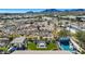 Aerial view of backyard with pool, fire pit, outdoor kitchen and desert landscape at 20641 W Medlock Dr, Buckeye, AZ 85396