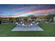 Backyard fire pit surrounded by seating offering views of lush landscaping and scenic mountain vistas at 20641 W Medlock Dr, Buckeye, AZ 85396