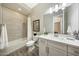 Bathroom with a shower-tub combo, single sink vanity, and tile flooring at 20641 W Medlock Dr, Buckeye, AZ 85396