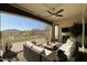 Relaxing covered patio seating area with views of the beautifully landscaped backyard and a mountain backdrop at 20641 W Medlock Dr, Buckeye, AZ 85396