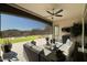 Relaxing covered patio seating area with views of the beautifully landscaped backyard and a mountain backdrop at 20641 W Medlock Dr, Buckeye, AZ 85396