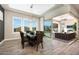 Dining room with dark wood table, patio access, and stunning views of the outdoor space at 20641 W Medlock Dr, Buckeye, AZ 85396