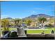 An outdoor fire pit with chairs surrounded by professionally landscaped desert flora and picturesque mountains at 20641 W Medlock Dr, Buckeye, AZ 85396