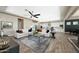 Bright living room with tile floors connects seamlessly to open kitchen with white cabinetry at 20641 W Medlock Dr, Buckeye, AZ 85396