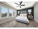 Bright main bedroom features wood-look floors, modern lighting, and backyard views from the large windows at 20641 W Medlock Dr, Buckeye, AZ 85396