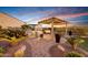 Beautiful outdoor kitchen and dining area under a pergola, ideal for entertaining guests at 20641 W Medlock Dr, Buckeye, AZ 85396