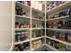 Well-organized walk-in pantry featuring custom shelving and various storage containers for food and household items at 20641 W Medlock Dr, Buckeye, AZ 85396