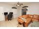 Living room featuring a brown leather sectional sofa and a workspace at 2150 W Alameda Rd # 1037, Phoenix, AZ 85085