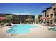 Community pool with lounge chairs and umbrellas at 2150 W Alameda Rd # 1037, Phoenix, AZ 85085