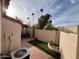 Private backyard with small lawn, brick patio, and trees at 2168 E Sanos Dr, Tempe, AZ 85281