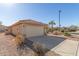 Tan house with a two-car garage and a small front yard at 23205 W Arrow Dr, Buckeye, AZ 85326