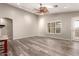 Bright living room featuring wood-look floors and a ceiling fan at 23205 W Arrow Dr, Buckeye, AZ 85326