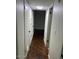 Bright hallway with dark hardwood floors and neutral walls at 2606 W Berridge Ln # C208, Phoenix, AZ 85017