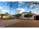 Landscaped backyard with patio, trees, and grassy area at 2614 E Mountain View Rd, Phoenix, AZ 85028