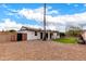 Charming backyard with grassy area and gravel driveway at 2614 E Mountain View Rd, Phoenix, AZ 85028