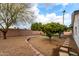 Backyard with gravel, trees, and a patio area at 2614 E Mountain View Rd, Phoenix, AZ 85028