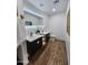 Modern bathroom featuring double sinks, lighted mirror, wood-look floors and sleek, modern fixtures at 2614 E Mountain View Rd, Phoenix, AZ 85028