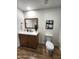 Traditional bathroom with oak vanity, black hardware, quartz countertops, and a comfort height toilet at 2614 E Mountain View Rd, Phoenix, AZ 85028