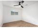 Simple bedroom featuring wood floors and a window at 2614 E Mountain View Rd, Phoenix, AZ 85028