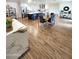 Open concept dining room and kitchen area, with a large marble-topped island and wood-style flooring at 2614 E Mountain View Rd, Phoenix, AZ 85028