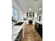 Bright kitchen featuring white cabinetry, stainless steel appliances, and a central island with a marble countertop at 2614 E Mountain View Rd, Phoenix, AZ 85028