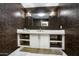 Modern bathroom with a floating vanity and dark patterned walls at 26905 N 98Th Way, Scottsdale, AZ 85262