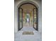 Grand entryway with arched doorways and a curved staircase at 26905 N 98Th Way, Scottsdale, AZ 85262