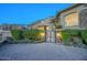 Elegant home entrance with a gated driveway and landscaping at 26905 N 98Th Way, Scottsdale, AZ 85262