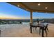 Covered patio with outdoor dining and stunning sunset views at 26905 N 98Th Way, Scottsdale, AZ 85262