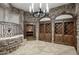 Elegant wine cellar with stone walls and custom wood cabinetry at 26905 N 98Th Way, Scottsdale, AZ 85262