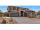 Two-story home with stone accents and a three-car garage at 2739 W Via Bona Fortuna Dr, Phoenix, AZ 85086