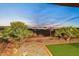 Artificial turf backyard with a fence and desert landscaping at 29432 N 128Th Ln, Peoria, AZ 85383